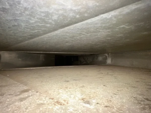 The same air duct after cleaning - bare galvanized metal
